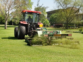 Tractor mowing acres of grass